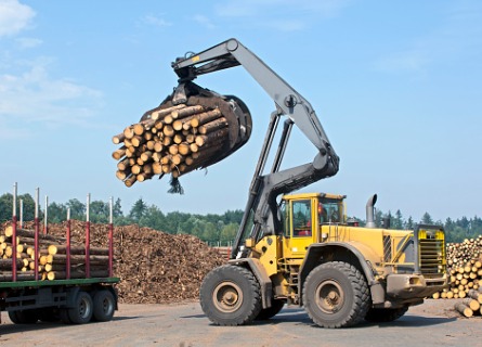 Wheel loader carries lumber, illustrating Timber Harvesting Cass County IL